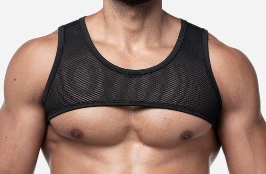 A close-up of a man's chest wearing a black mesh underboob band, shown against a plain light gray background.  The brand name is PUMP.