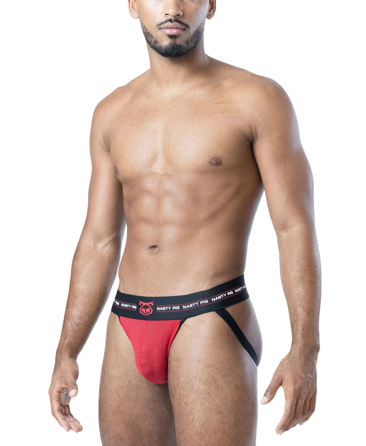 A man modeling a red mesh thong-style brief with a black waistband featuring white 'NASTY PIG' branding and a small red logo, against a plain white background.